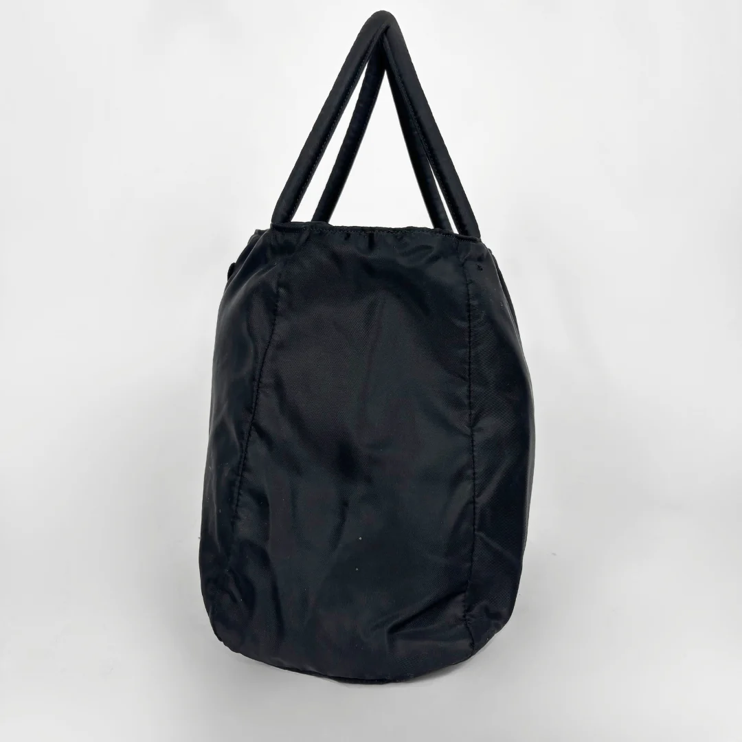 Prada black nylon tote bag with top handles and the classic enamel triangle logo.