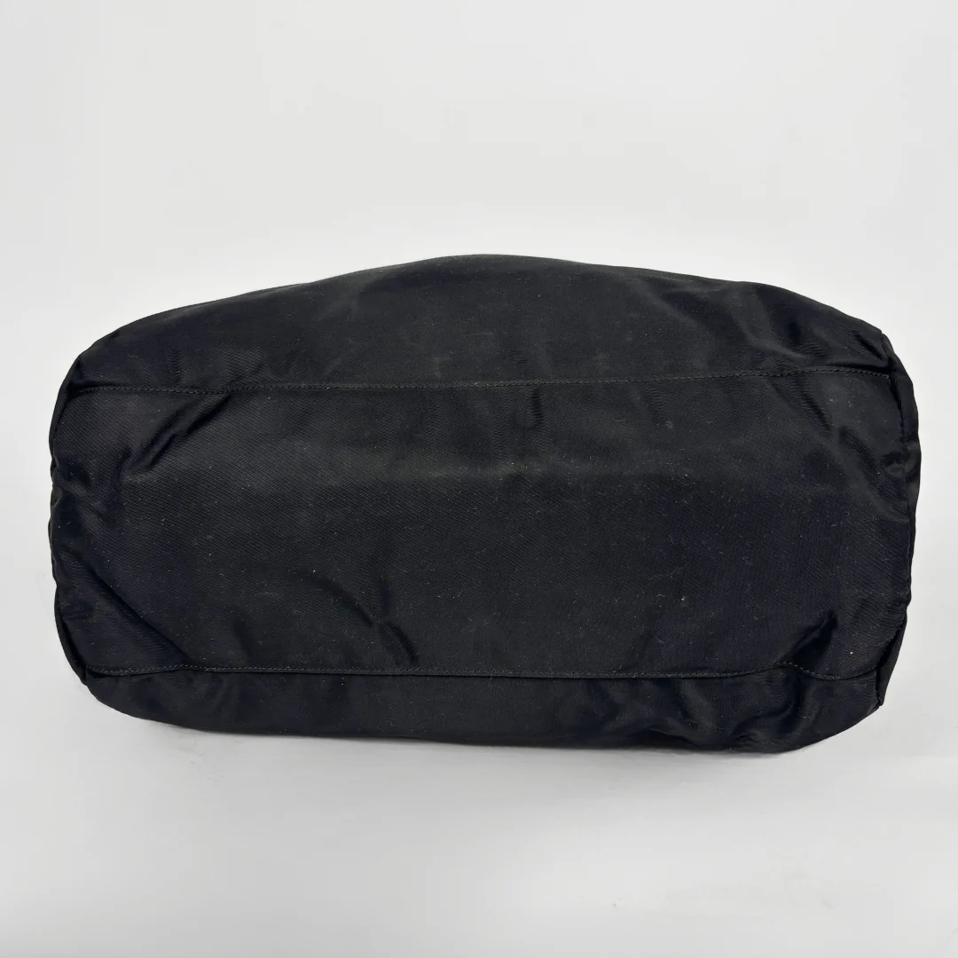Prada black nylon tote bag with top handles and the classic enamel triangle logo.