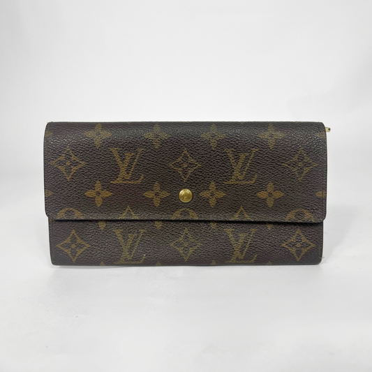 Louis Vuitton wallet with monogram pattern on a white background