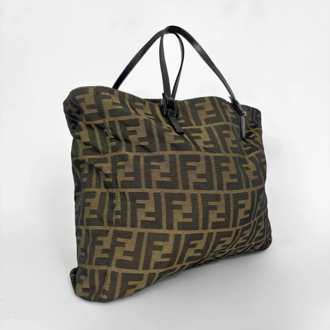 Fendi shopper bag in brown and black Zucca monogram canvas with black leather handles.