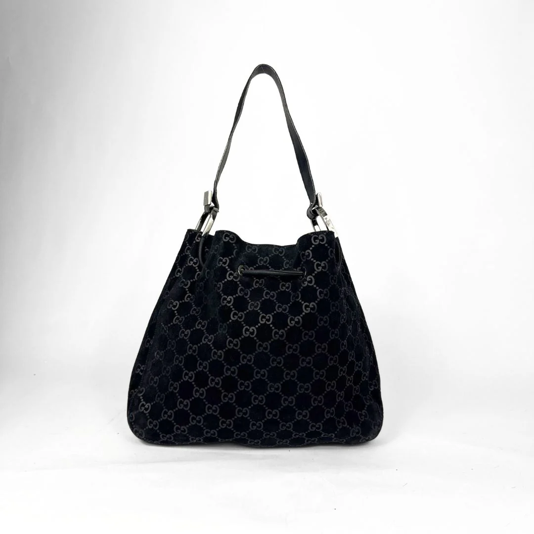 Black patterned handbag on a white background