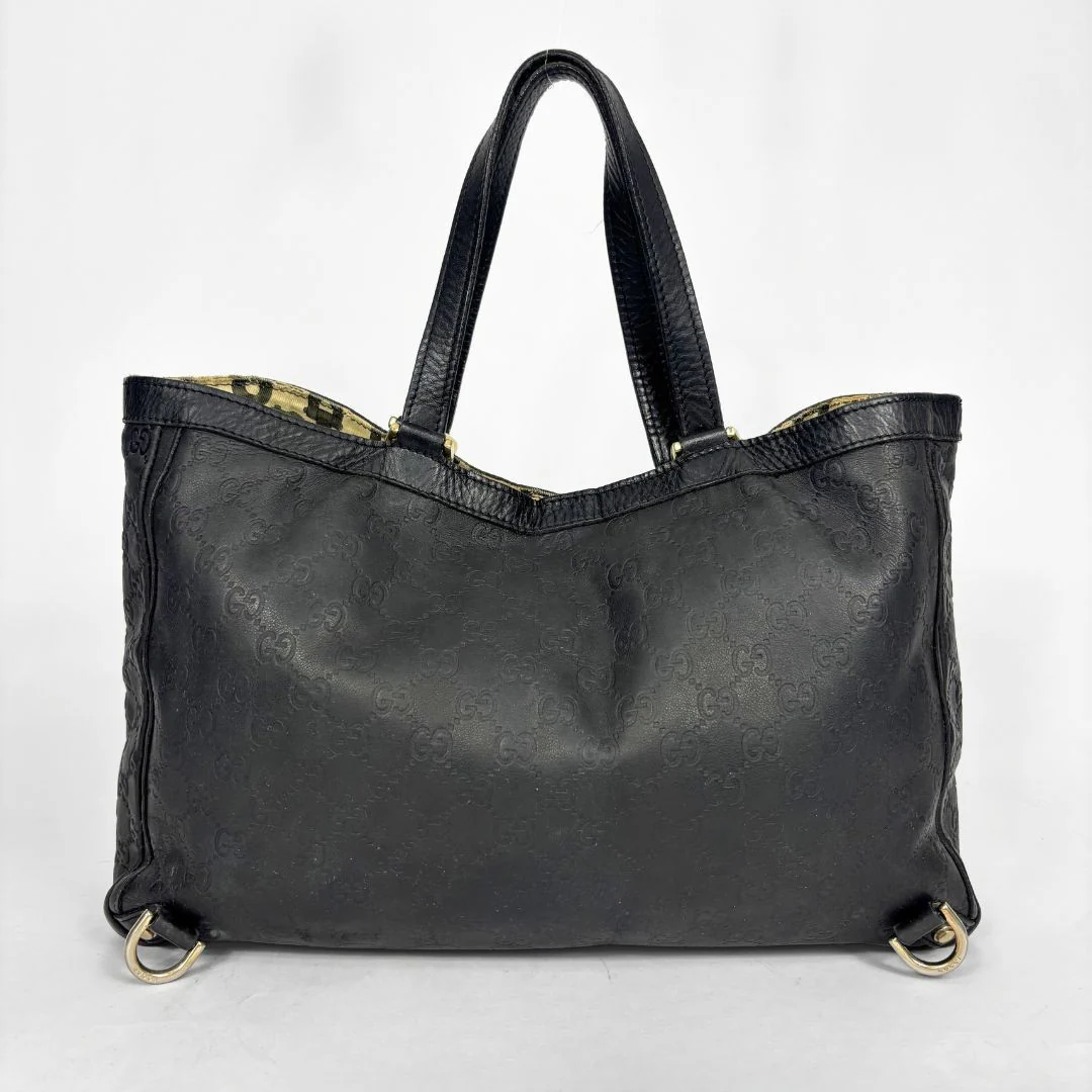 Black Gucci handbag on a white background