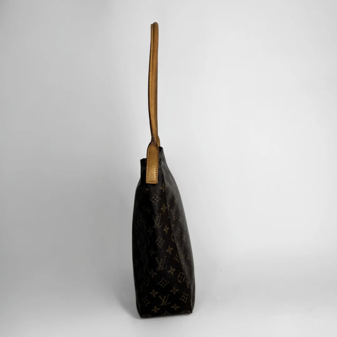 Louis Vuitton monogram canvas shoulder bag in dark brown with tan leather trim and strap, shown from a side profile view against a light gray background.