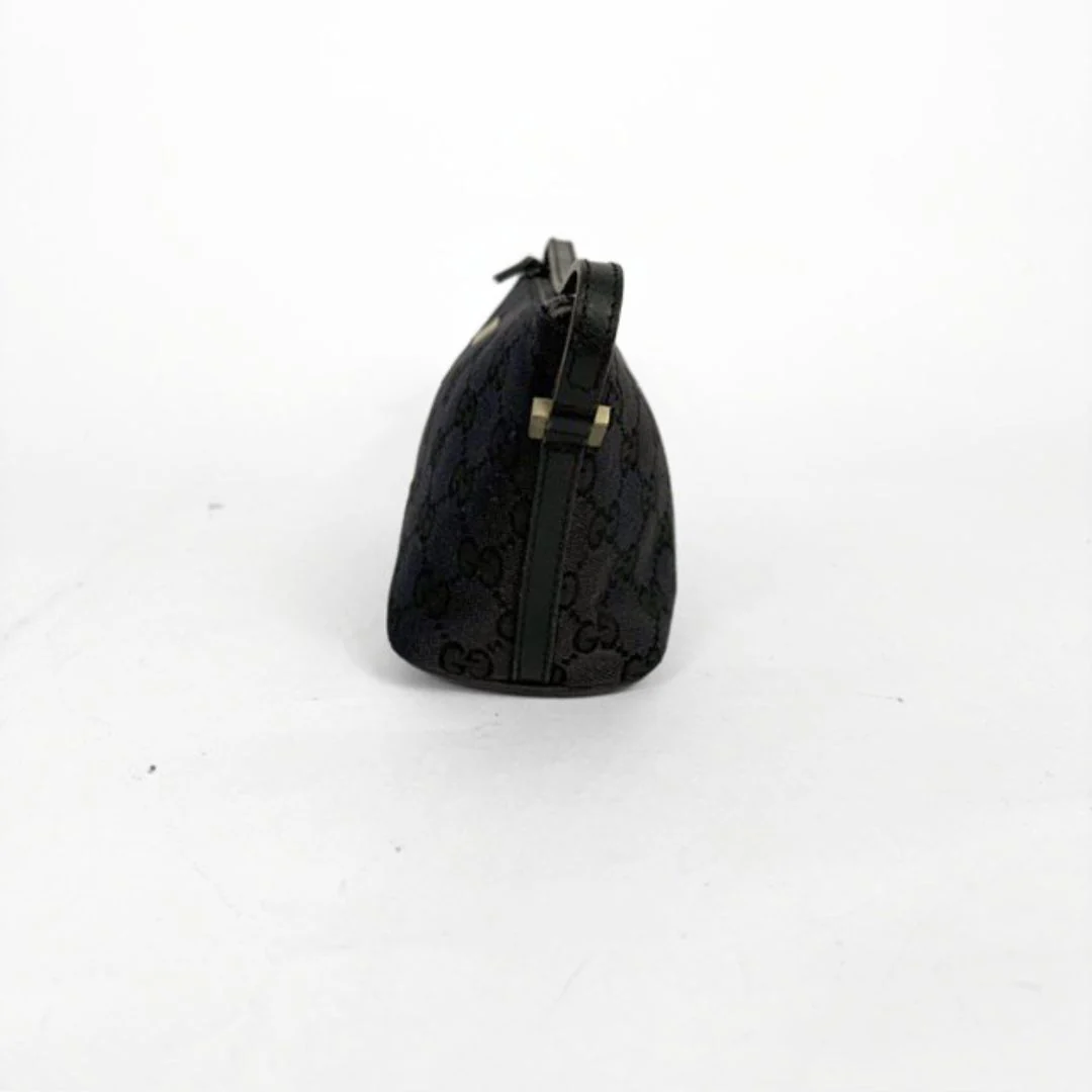 Black handbag with a pattern on a white background