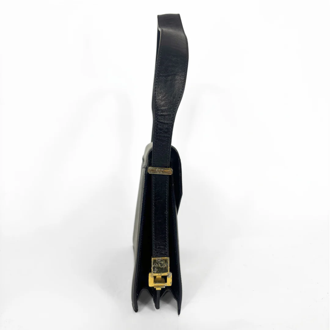 Celine vintage black leather shoulder bag with gold-tone horse and cariage buckle.