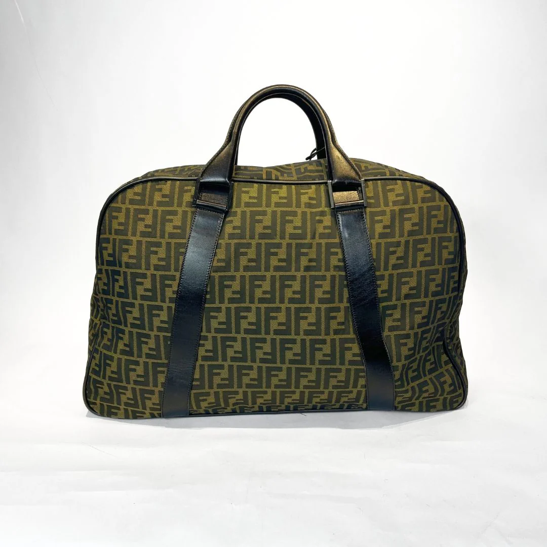 Green travel bag with black straps on a white background