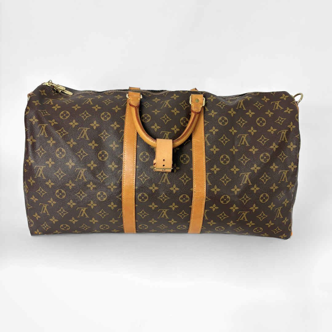 Brown travel bag with tan handles and trim on a white background