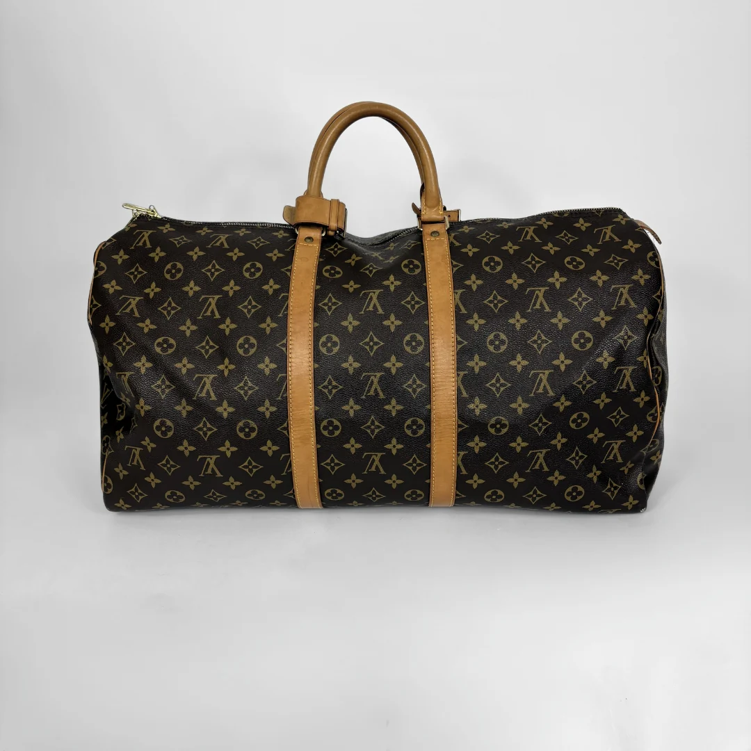Designer duffel bag with monogram pattern on a white background