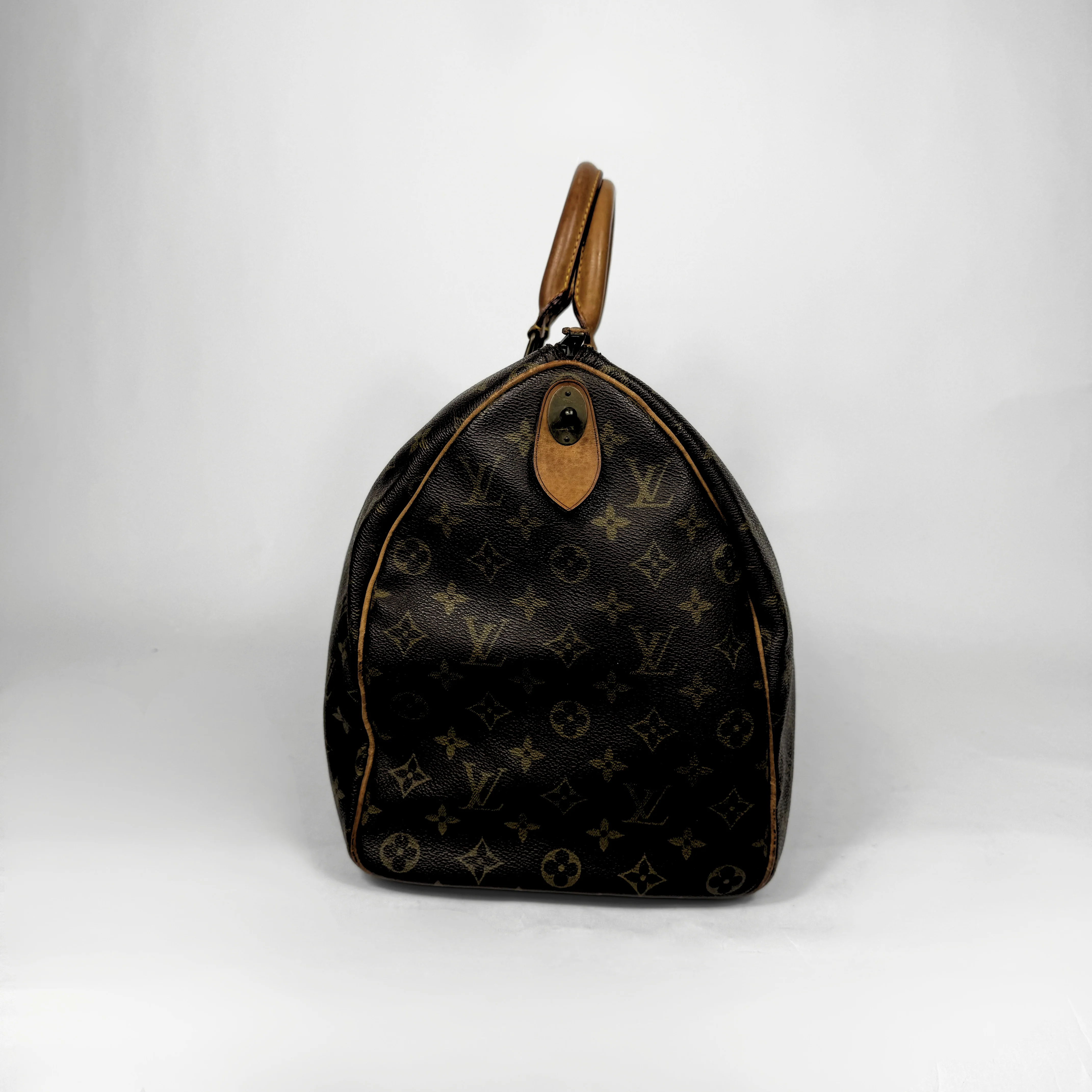 Designer handbag with monogram pattern on a white background