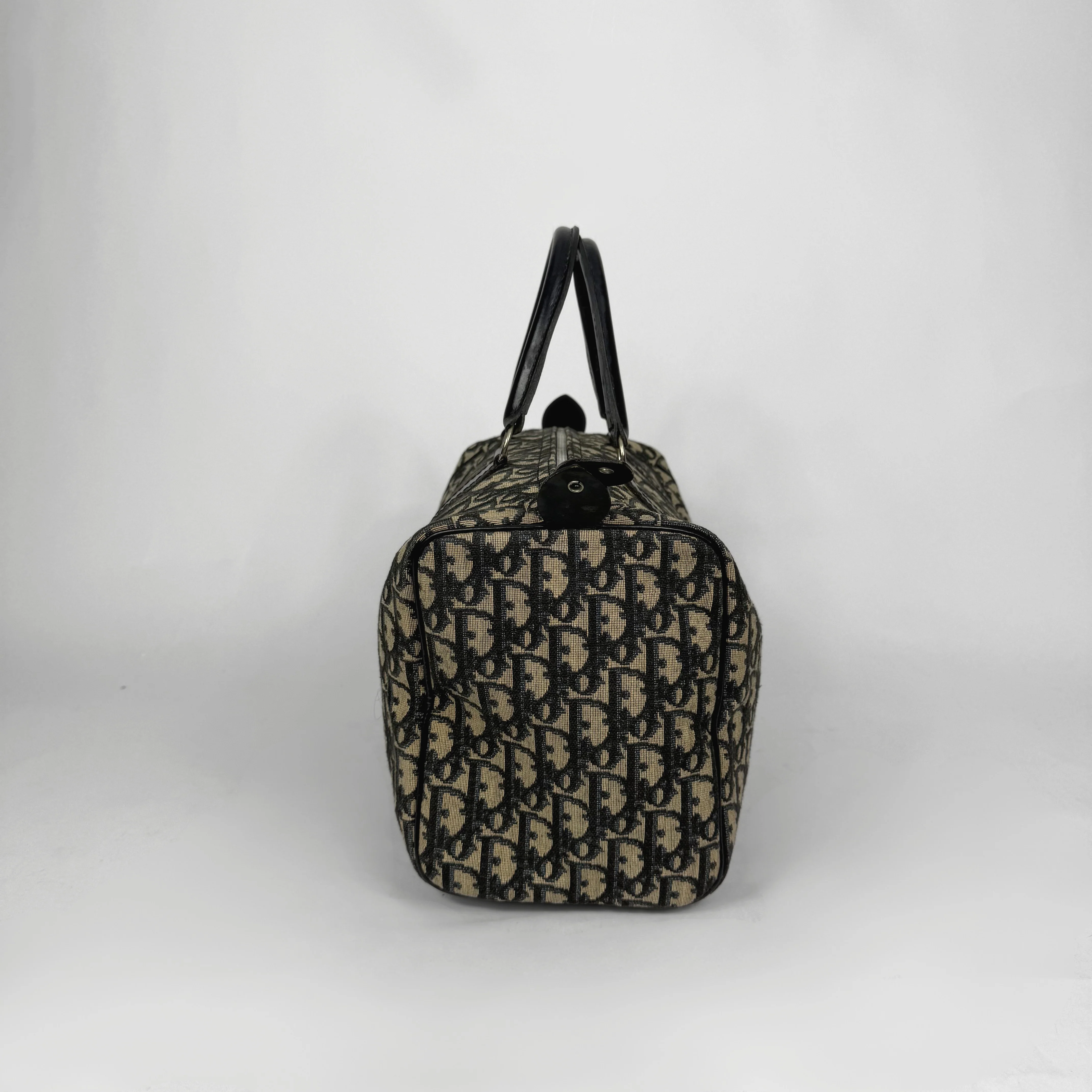 Designer handbag with monogram pattern on a white background