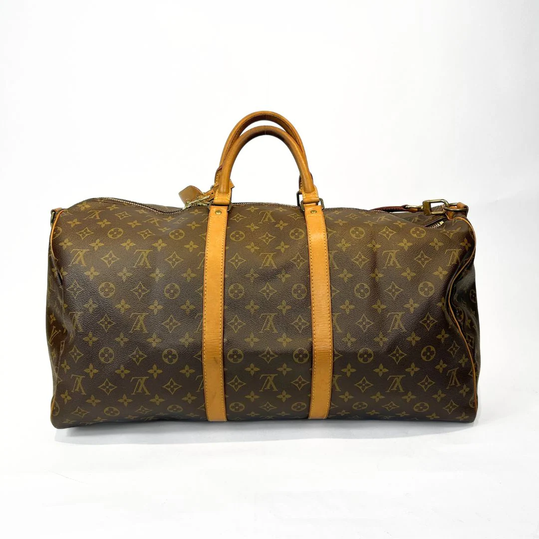 Brown travel bag with yellow accents on a white background