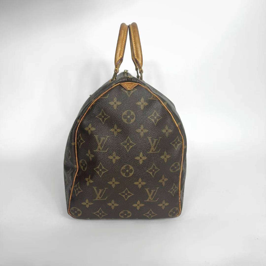 Brown handbag with a monogram pattern on a white background