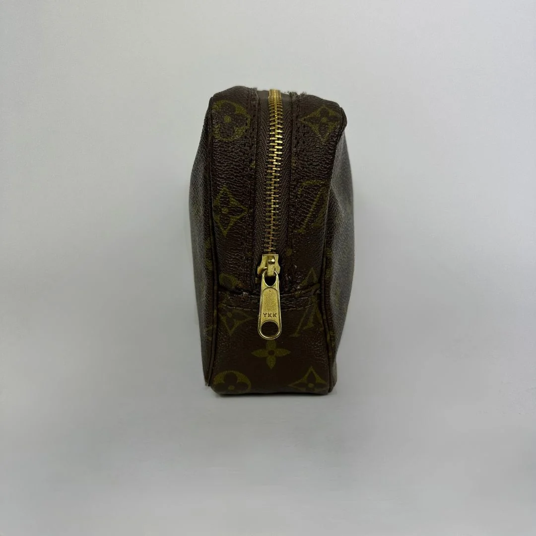 Louis Vuitton toiletry bag in front of white background
