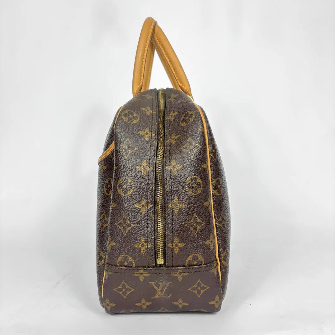 Designer handbag with monogram pattern on a white background