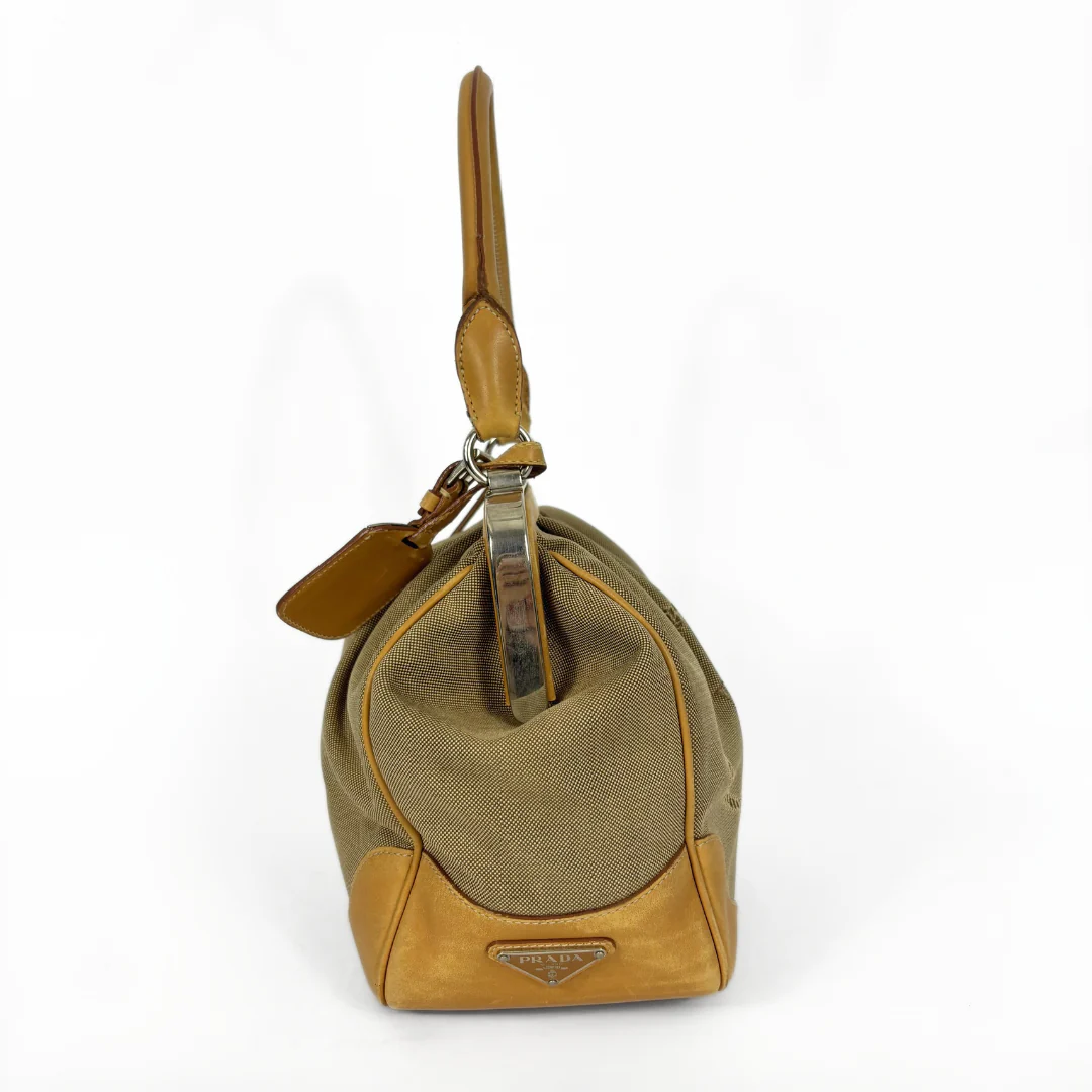 Brown handbag with a visible brand logo on a white background