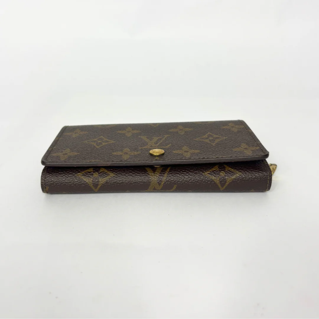 Brown wallet with gold accents on a white background