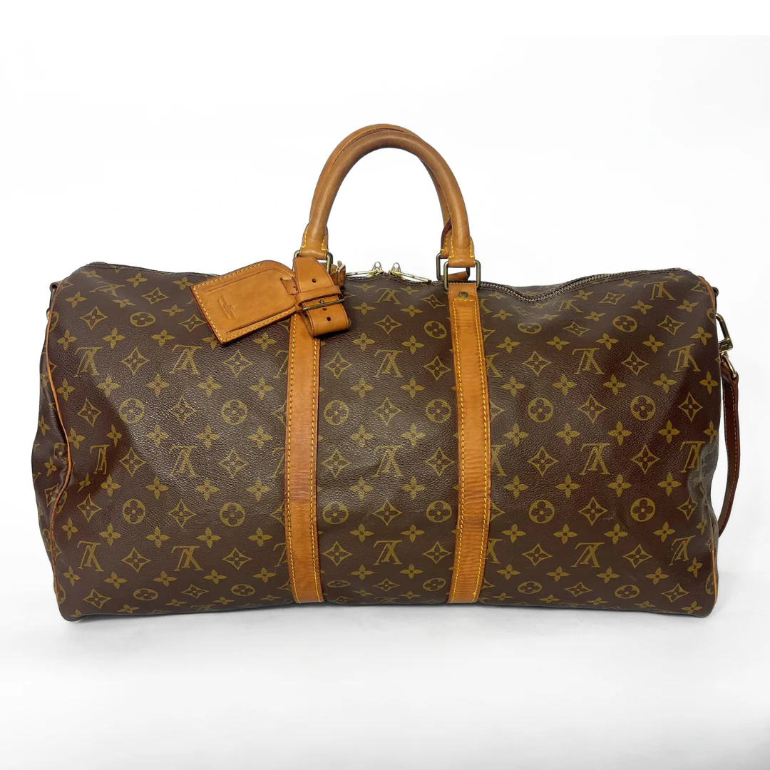 Brown travel bag with monogram pattern on a white background