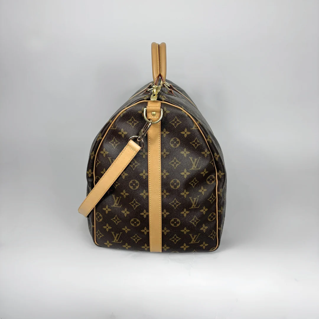 Designer handbag with monogram pattern on a light gray background