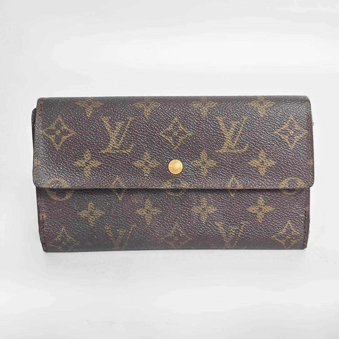 Louis Vuitton wallet with monogram pattern on a white background