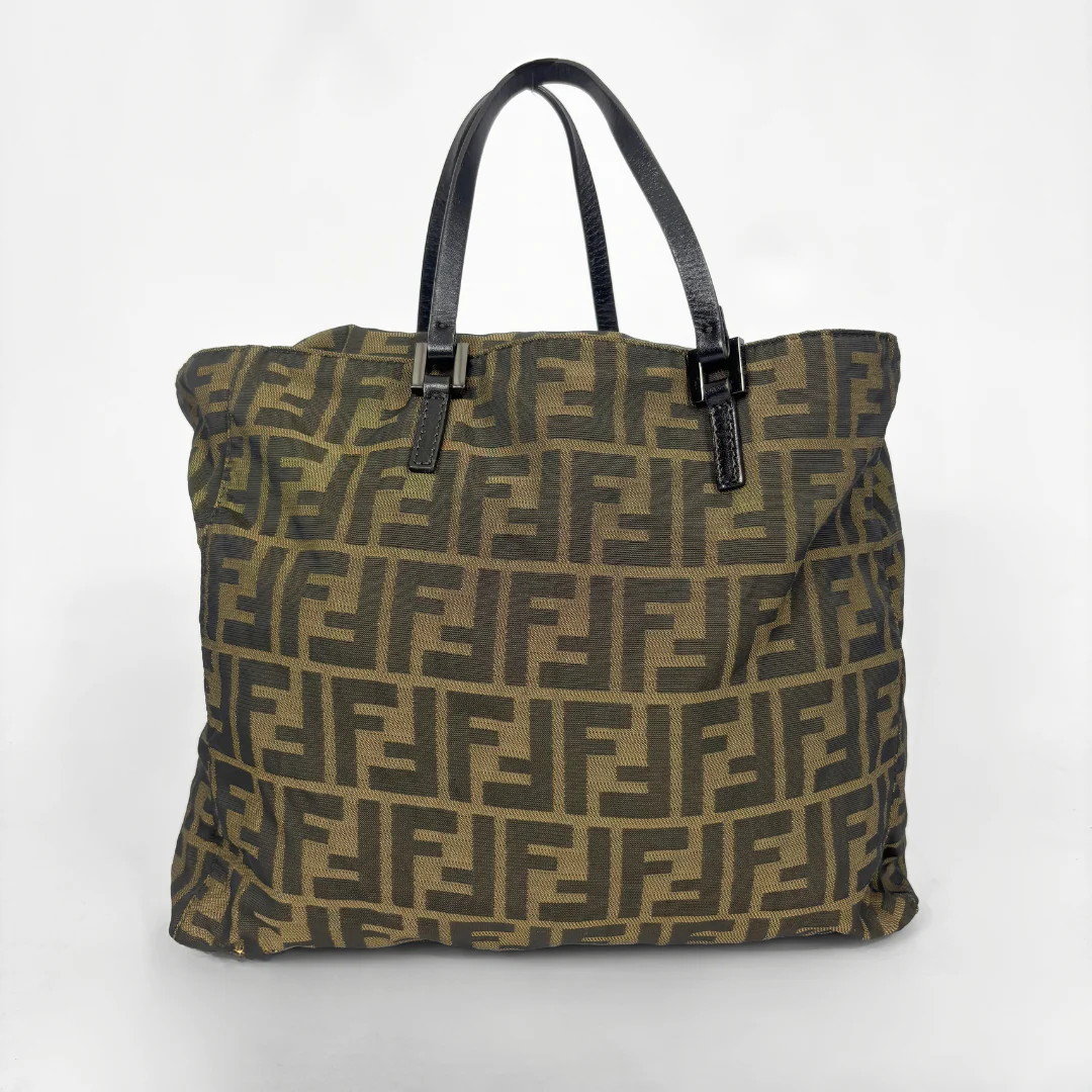 Fendi shopper bag in brown and black Zucca monogram canvas with black leather handles.