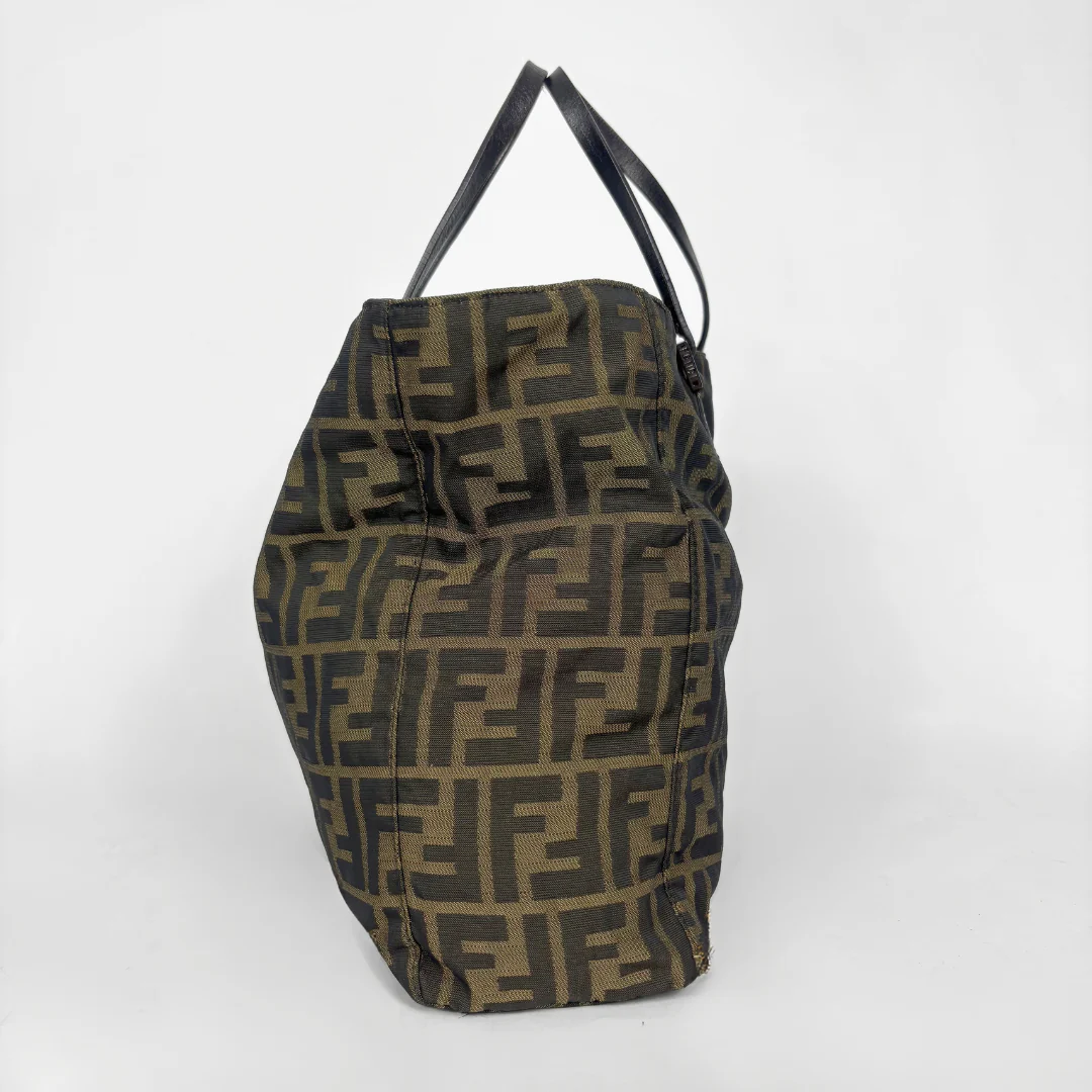 Fendi shopper bag in brown and black Zucca monogram canvas with black leather handles.