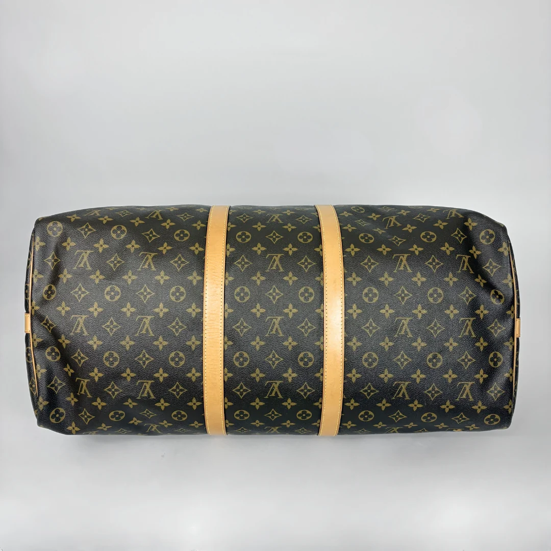 Louis Vuitton monogram duffel bag on a light gray background
