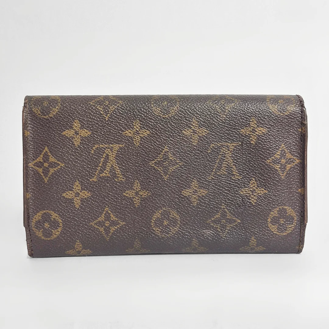 Brown wallet with monogram pattern on a white background
