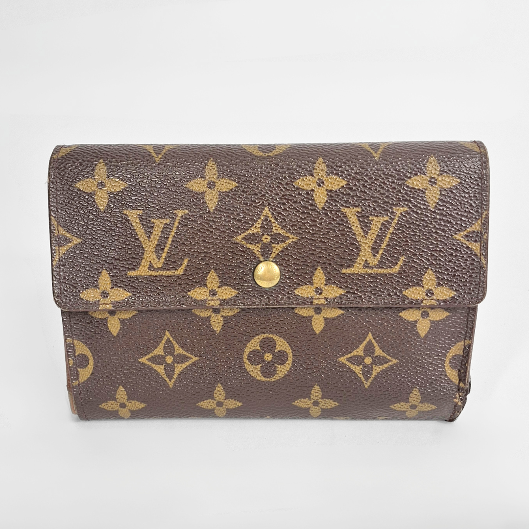 Louis Vuitton wallet with monogram pattern on a white background