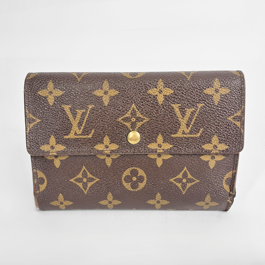 Louis Vuitton wallet with monogram pattern on a white background