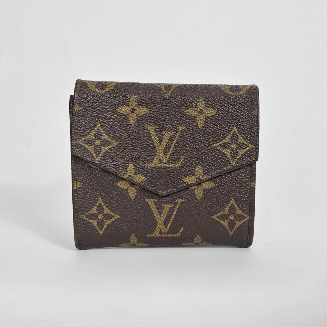 Louis Vuitton wallet with monogram pattern on a light gray background