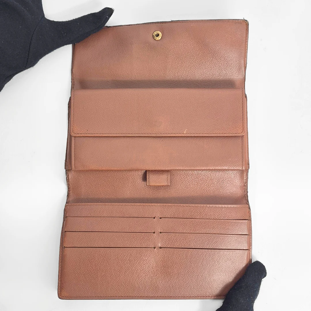 Brown leather wallet with multiple card slots on a white background