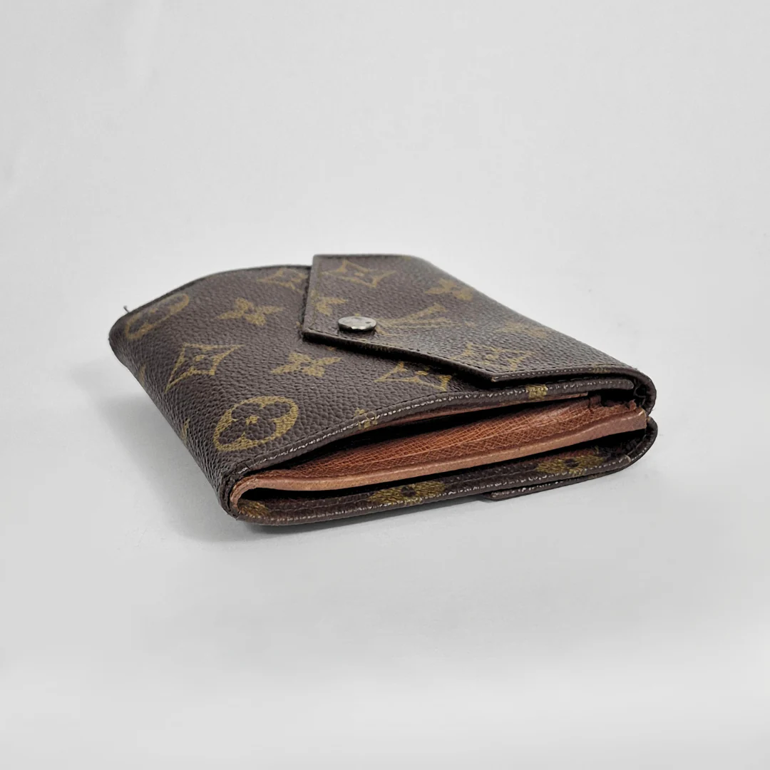 Brown monogrammed wallet on a light gray background