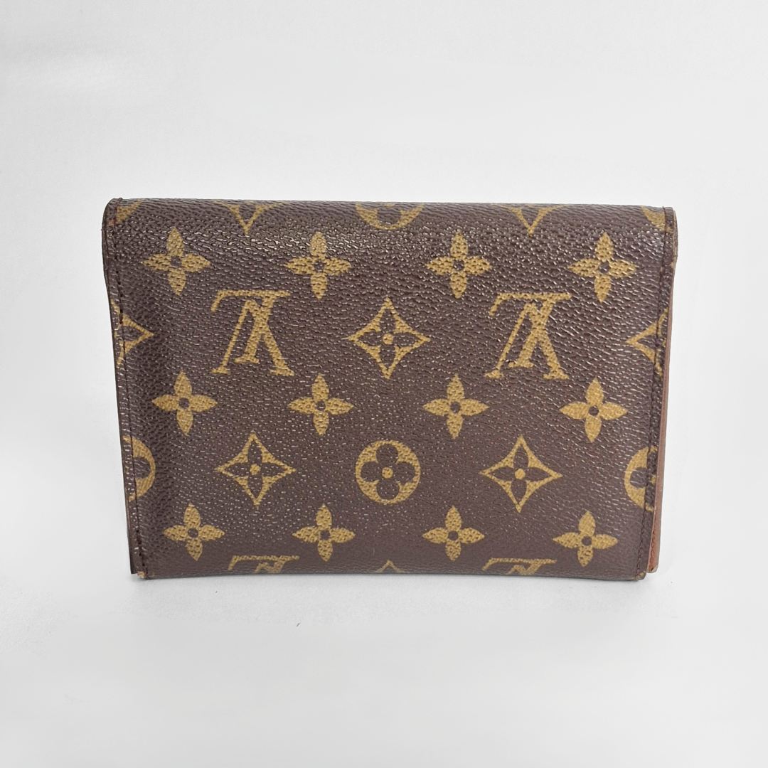 Louis Vuitton wallet with monogram pattern on a white background