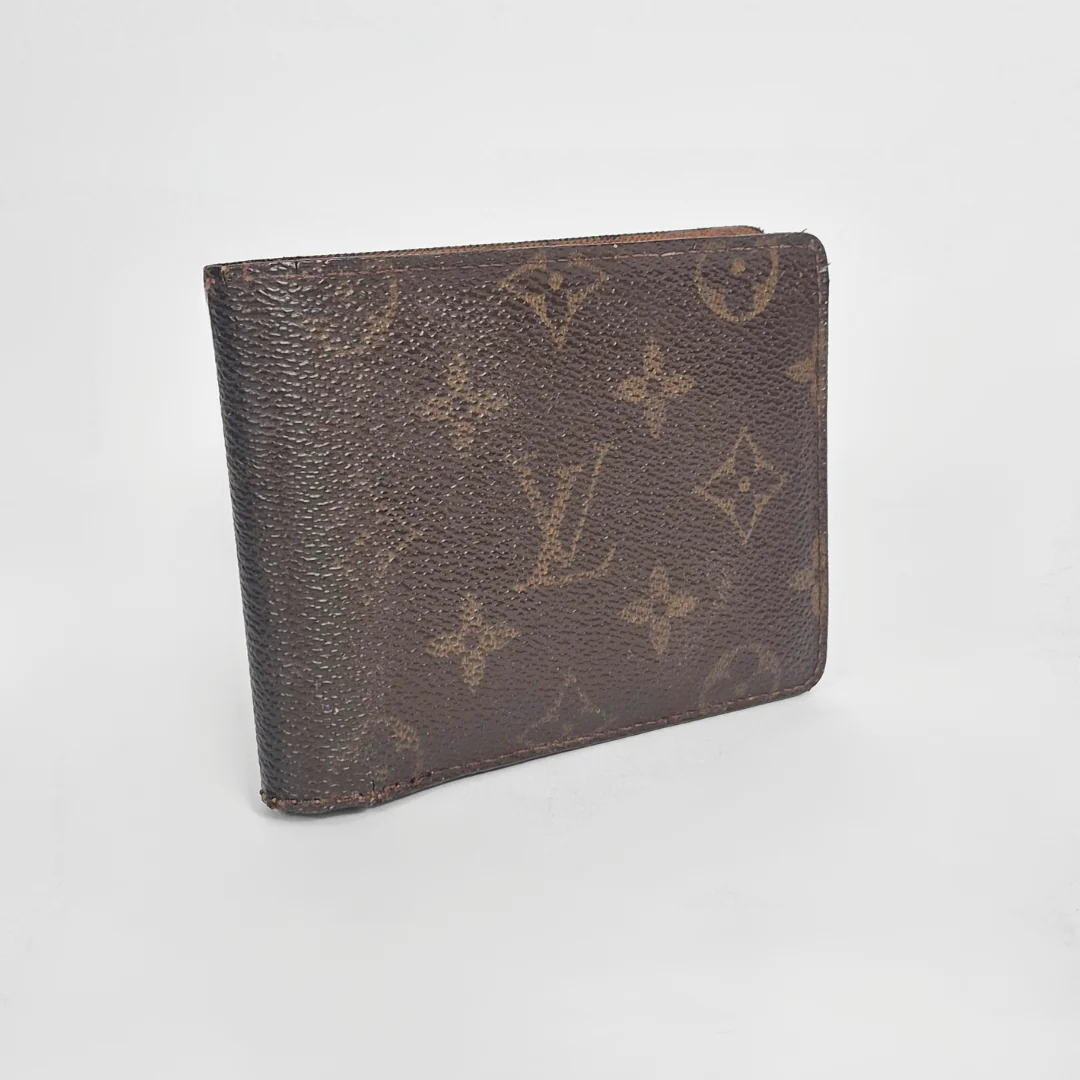 Brown wallet with monogram pattern on a light gray background