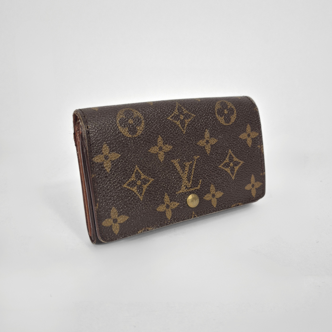 Louis Vuitton wallet with monogram pattern on a white background