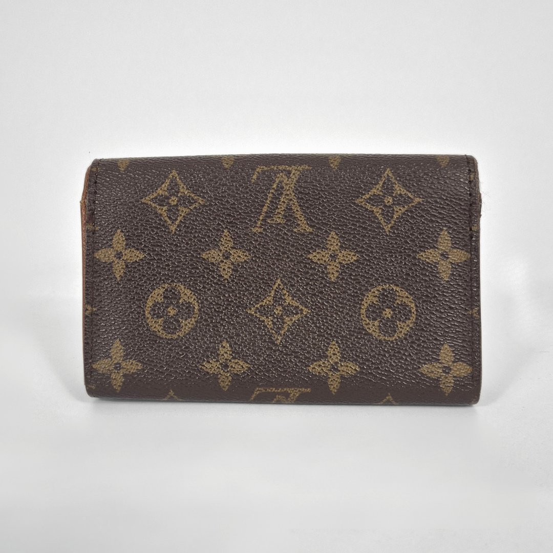 Louis Vuitton wallet with monogram pattern on a white background