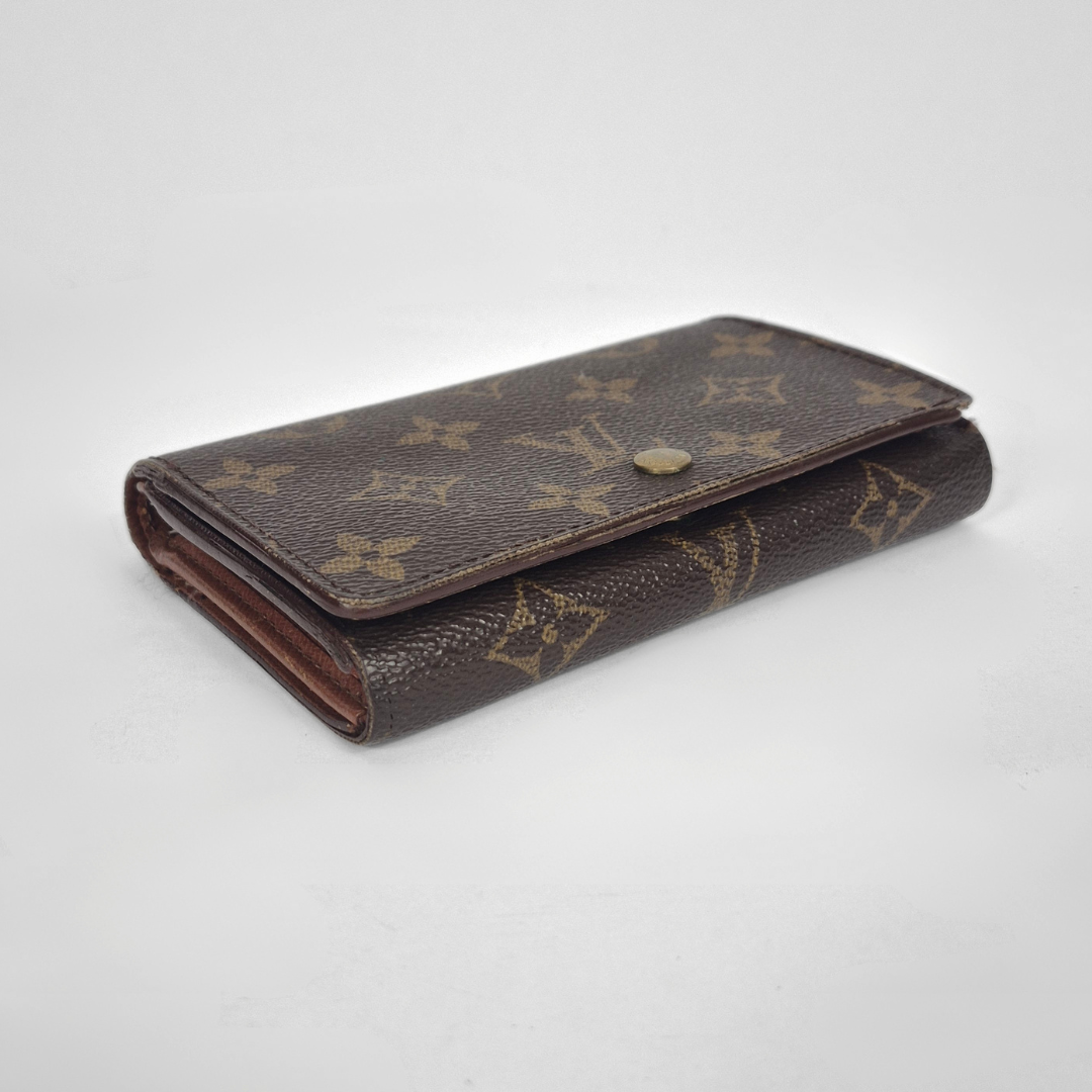 Louis Vuitton wallet with monogram pattern on a white background