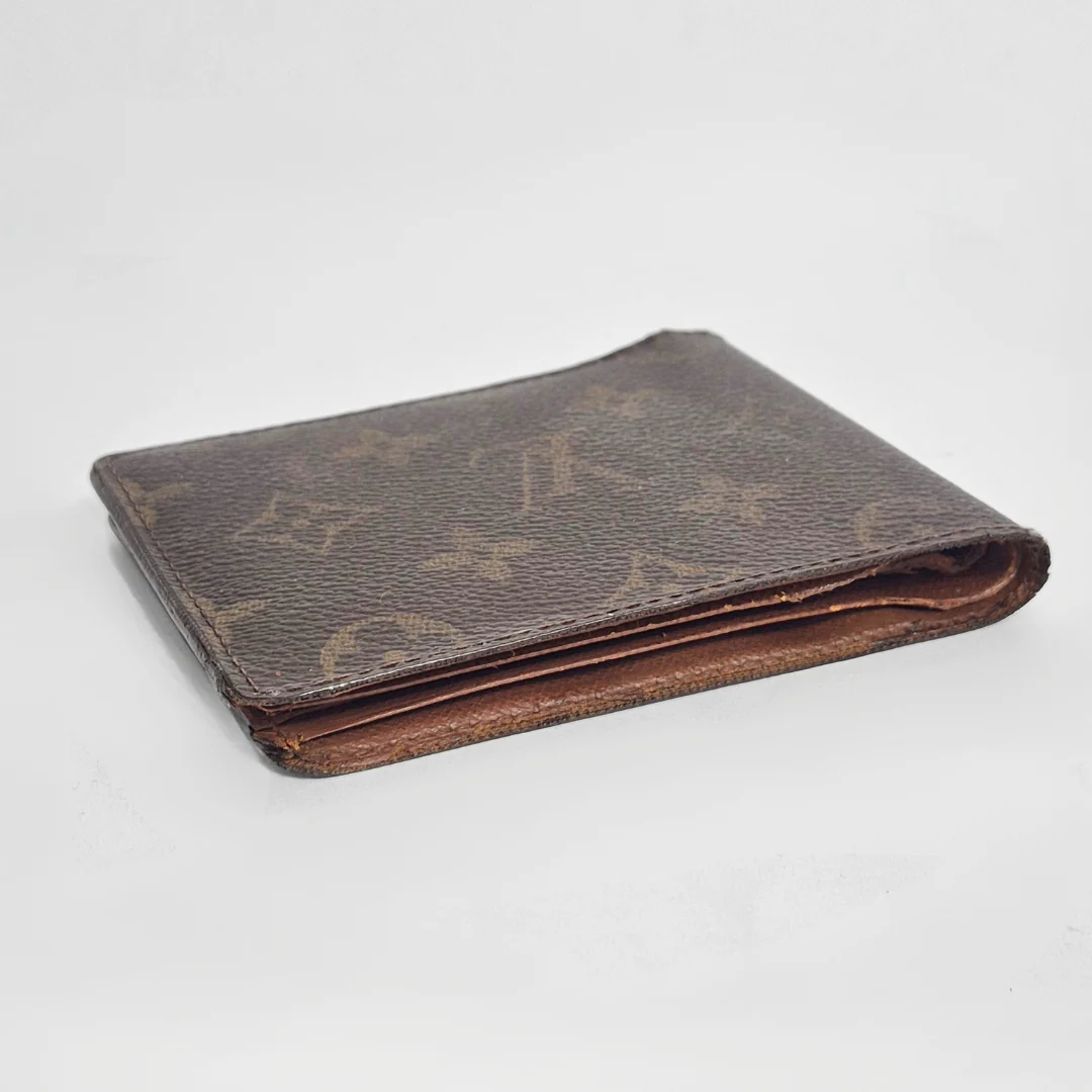 Brown leather wallet on a light gray background