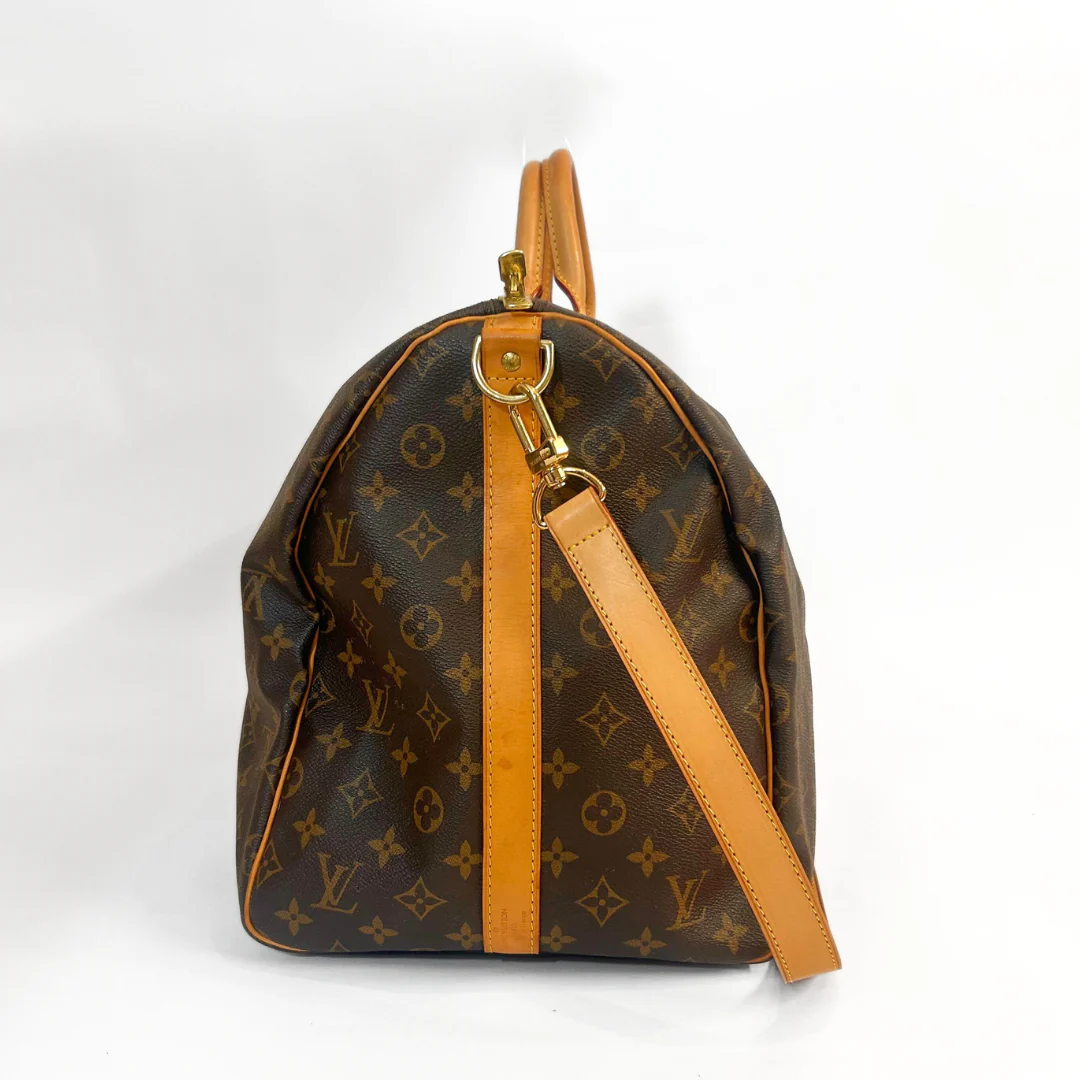Designer handbag with monogram pattern on a white background