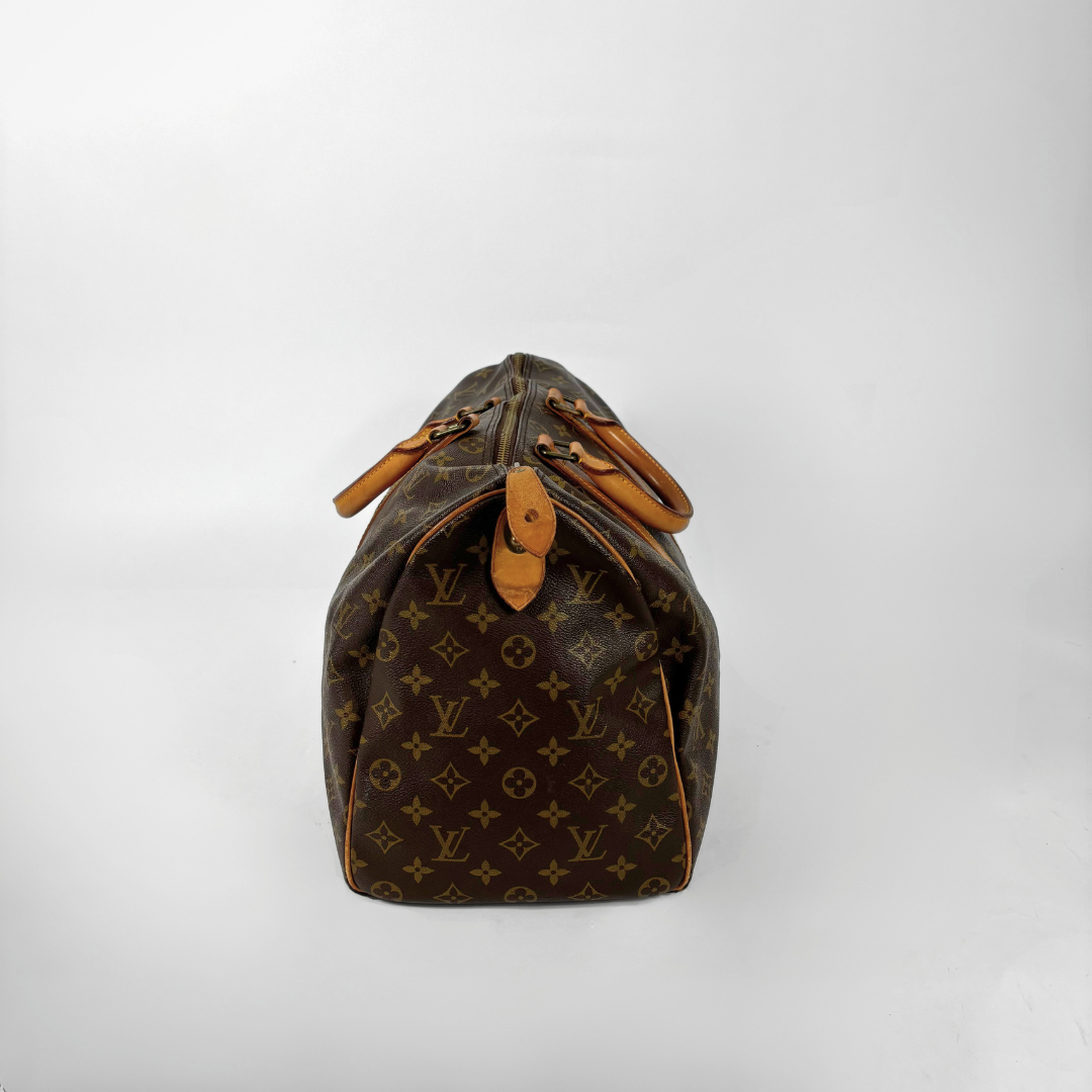 Brown Louis Vuitton handbag with monogram pattern on a white background