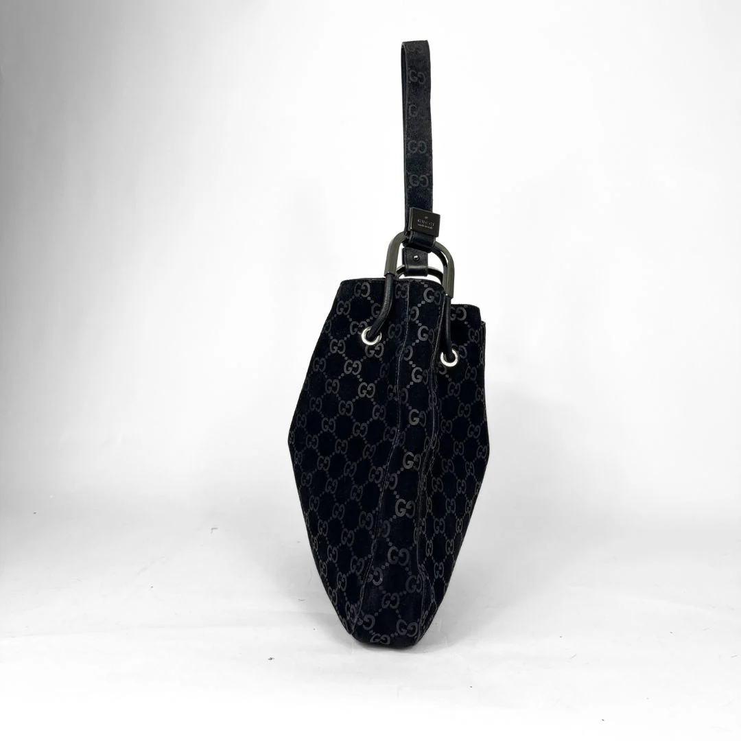 Black handbag with a pattern on a white background