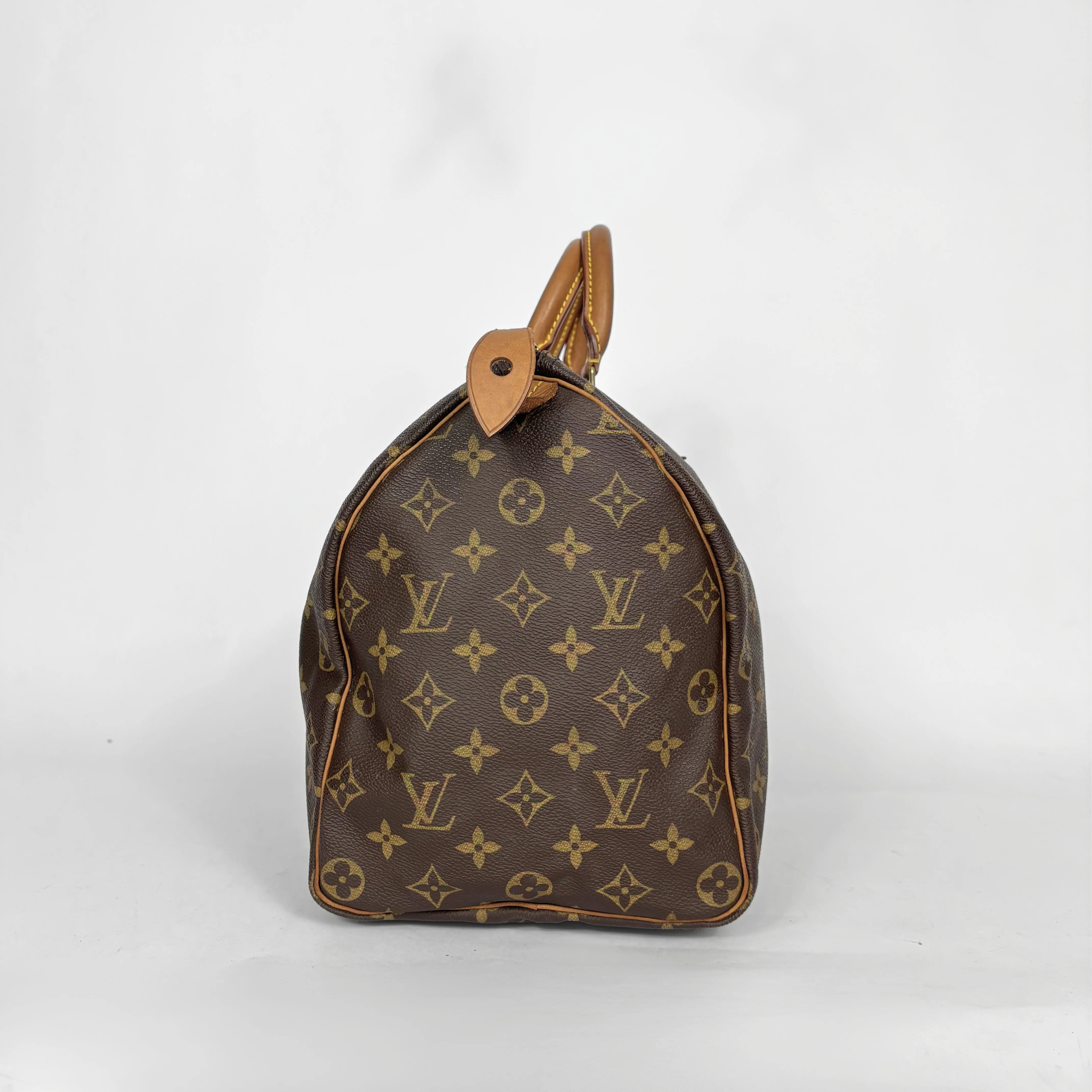 Brown handbag with a monogram pattern on a white background