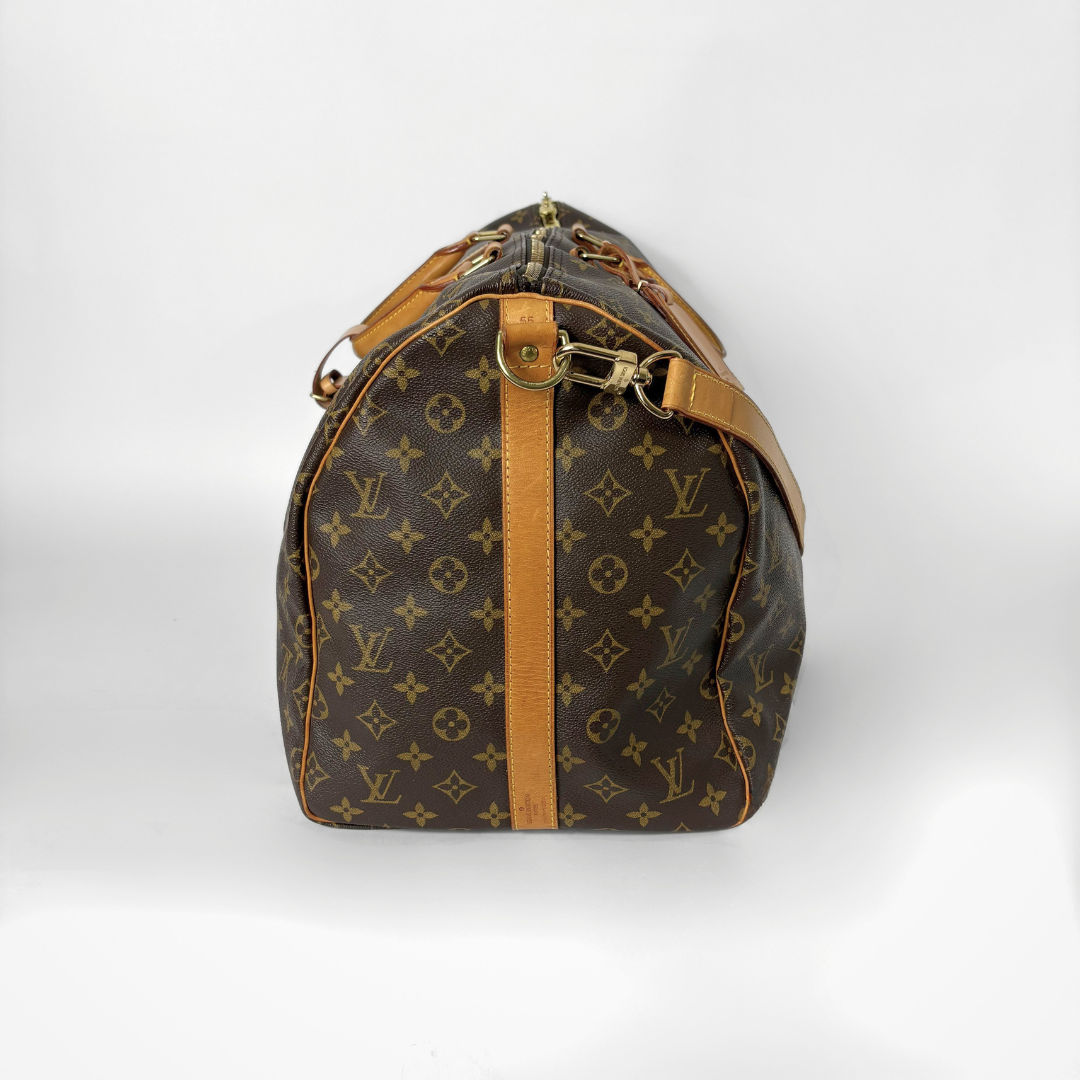 Brown monogram duffel bag with tan leather straps on a white background