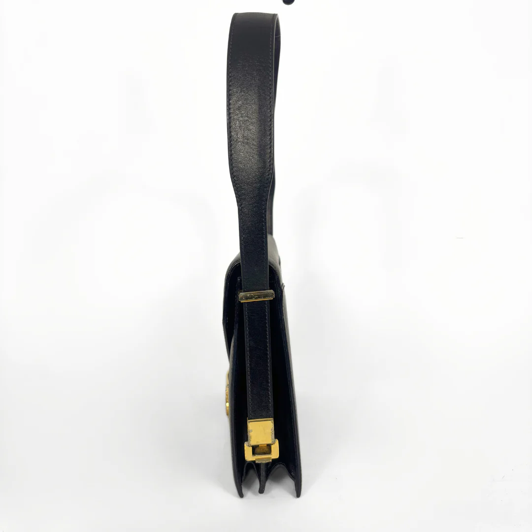 Celine vintage black leather shoulder bag with gold-tone horse and cariage buckle.