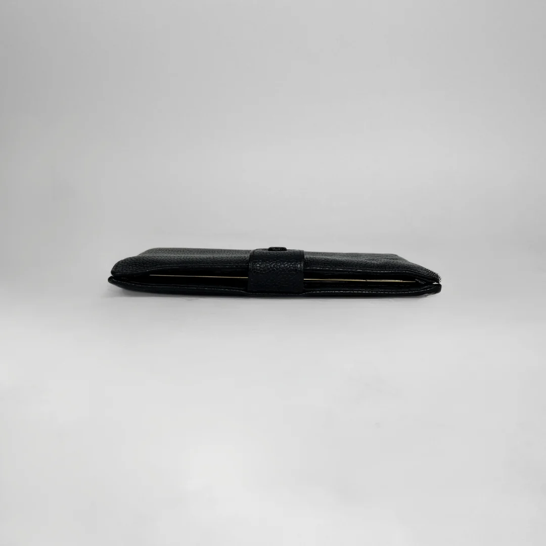A black textured leather wallet shown closed in a horizontal orientation on a light gray studio background.