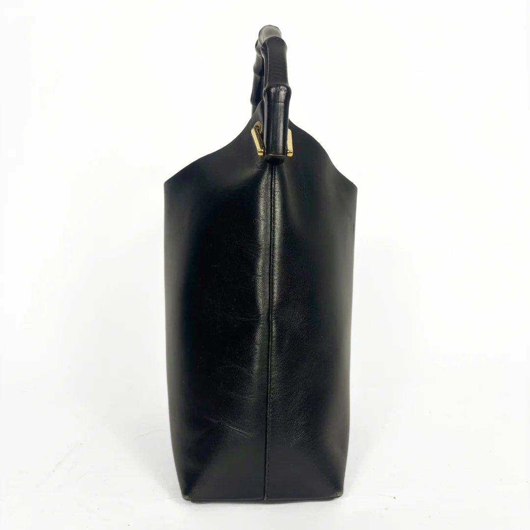 Gucci vintage black leather hobo hag with a dark wood bamboo top handle and gold-tone hardware.