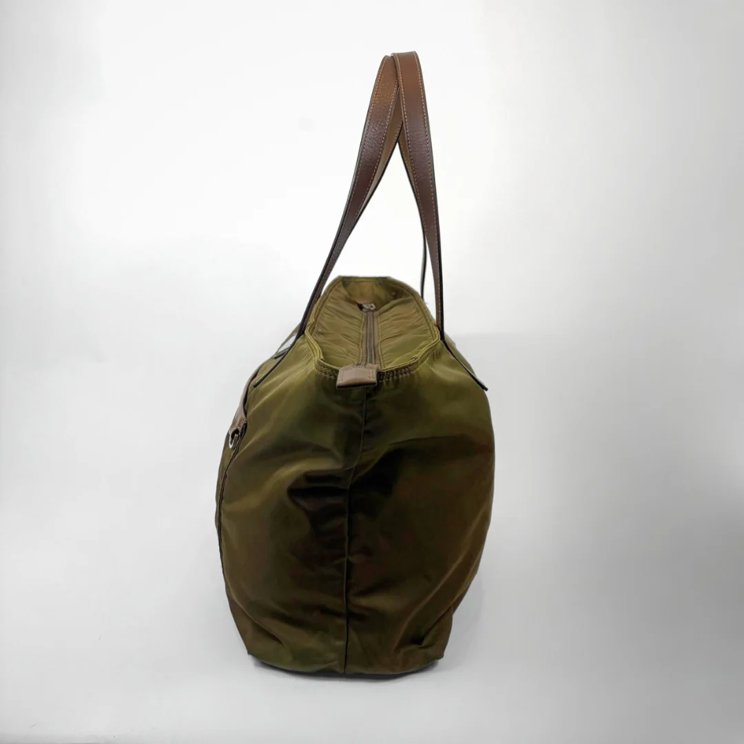 Green bag with brown handle on a white background