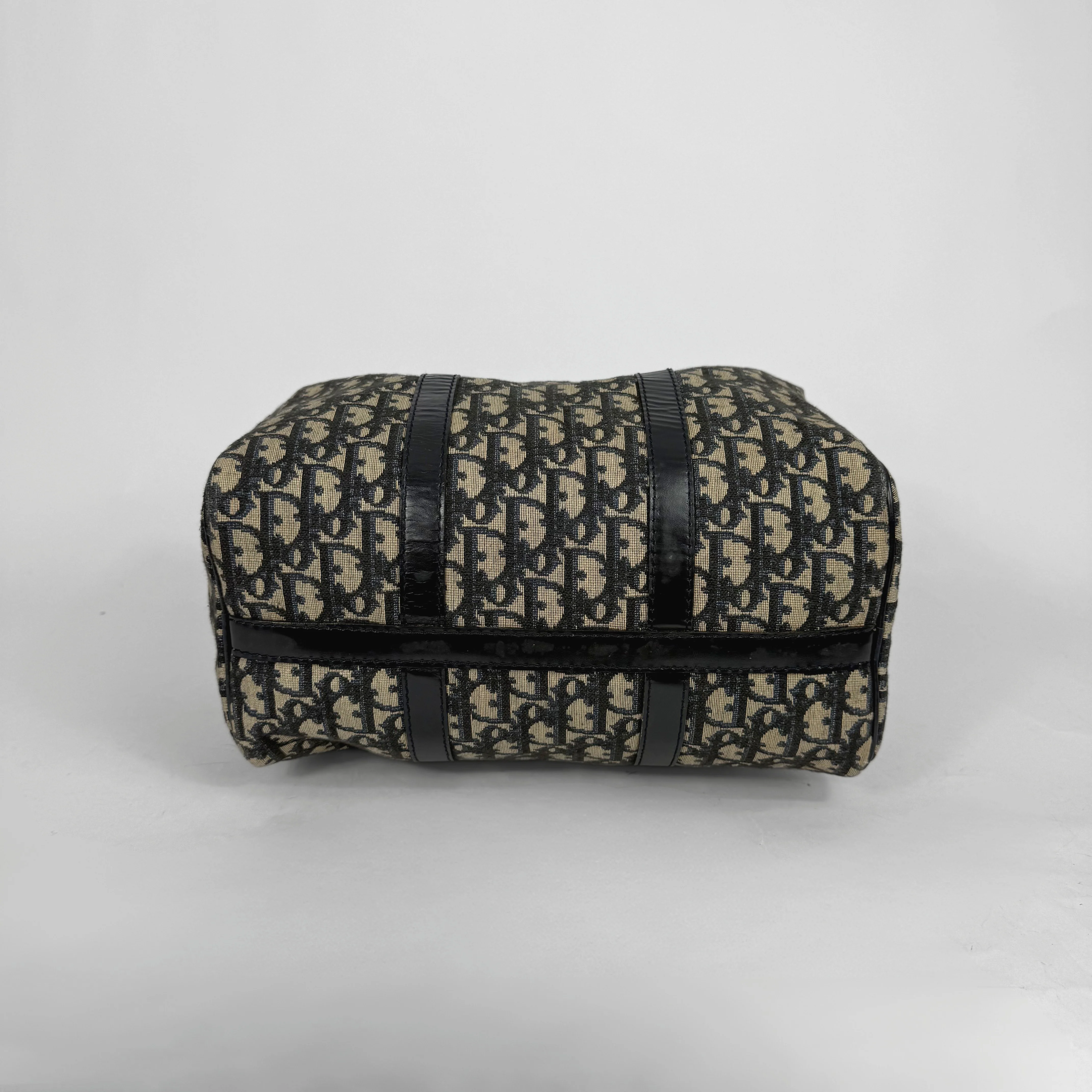 Patterned pouch with black straps on a light gray background