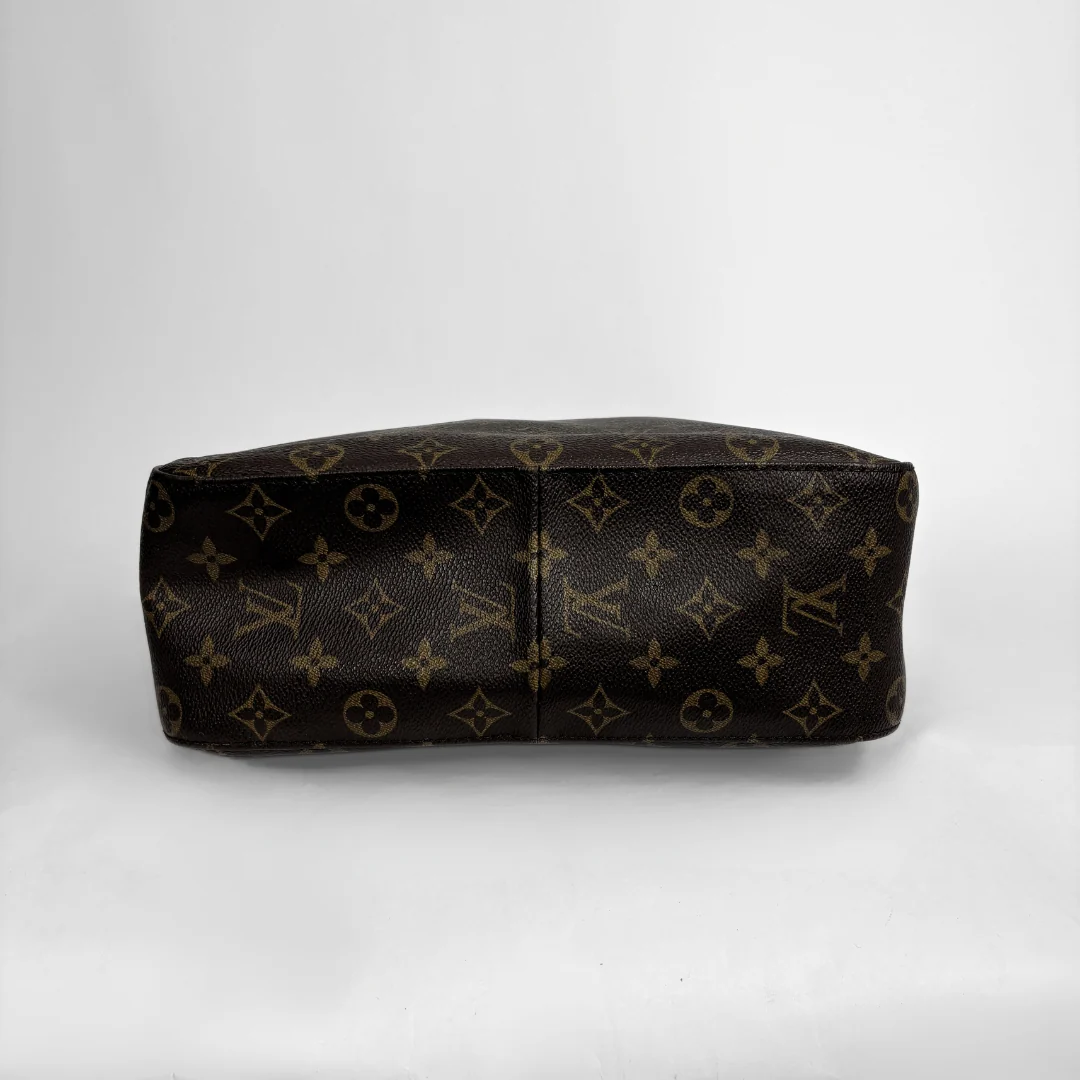 Louis Vuitton monogram canvas handbag shown from the back, featuring the classic dark brown and tan monogram pattern on a light gray background.