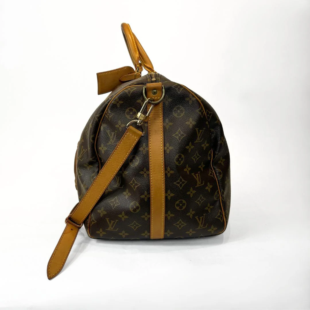 Brown monogram handbag with tan leather accents on a white background